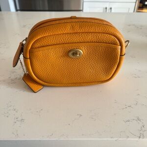 Coach Pebbled Leather Crossbody in papaya orange and pink strap